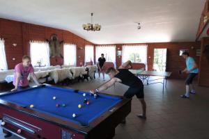 a group of people playing pool in a room at Gościniec Pogobie in Pogobie Średnie