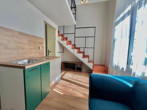 a kitchen with a sink and a staircase at Just Home in Varna City