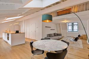 a living room with a table and chairs at Loft City Center - 1 bedroom - parking - by FineNest in Liège