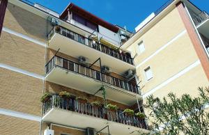 a building with balconies and potted plants on it at G&G - Bed & Breakfast in Vieste