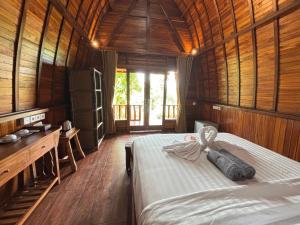 Postel nebo postele na pokoji v ubytování Ringsun Homestay Uluwatu