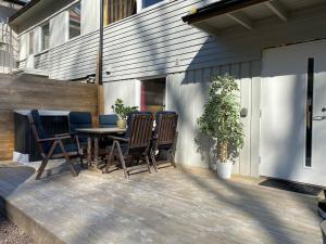 a patio with a wooden table and chairs at Townhouse in Tønsberg +22 photos