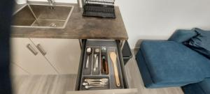 a kitchen with a counter with a sink and a blue couch at Aenaon Corfu Luxury Apartments #04 - Aphrodite Apartment in Ýpsos