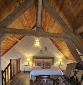 a bedroom with a bed in an attic at Maisons du Cerf et du Tilleul in Châtillon-sur-Cher +46 photos