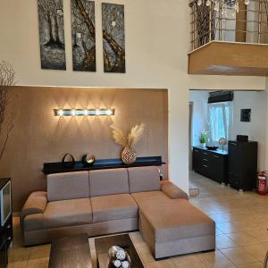 a living room with a couch and a table at paralia ofriniou beautiful house in Karianí