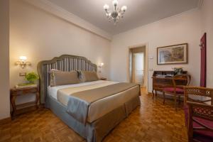 a bedroom with a large bed and a desk at Hotel Forum in Rome +135 photos
