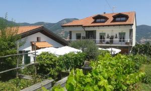 a house with a bunch of vines in front of it at The Cliff Amalfi Coast - Apartment 1 in Pianillo