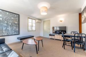 a living room with a couch and a table at Les Lices A l Cozy & Central l Shellter Rentals in Saint-Tropez