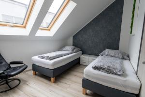 A bed or beds in a room at Jókai Apartman