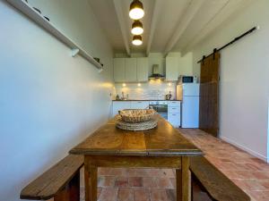 a kitchen with a wooden table in a room at Ty Cosy-Charme et Confort au Coeur de la Bretagne in Plouézec