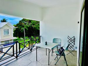 a patio with a table and chairs on a balcony at Refresh Holidays in Trou aux Biches