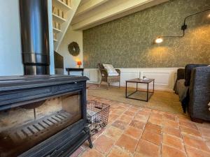a living room with a fireplace and a couch at Ty Cosy-Charme et Confort au Coeur de la Bretagne in Plouézec +39 photos