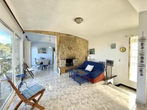 a living room with a blue couch and a fireplace at casa 7 pins in Begur