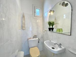 a white bathroom with a toilet and a sink at casa 7 pins in Begur +28 photos