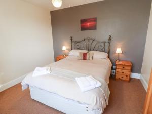 a bedroom with a bed with two towels on it at South View in Leyburn