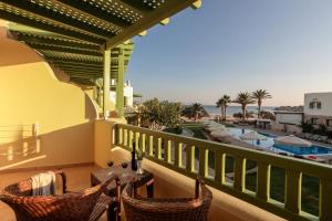 a balcony with a view of the beach and the ocean at Finikas Hotel in Aliko Beach