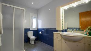 a bathroom with a sink and a toilet and a mirror at Casa Cruces in Sant Jaume d'Enveja +31 photos