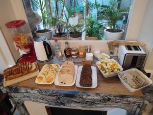 a table with many different types of food on it at L'Echappée Belle in Chartres