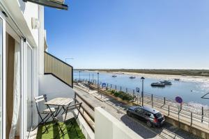 a car parked on a balcony with a view of the water at Cabanas de Tavira - T1 in Cabanas de Tavira