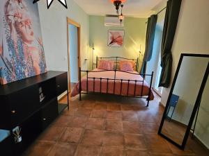 a bedroom with a bed and a dresser at Olé Toledo in Cómpeta +34 photos