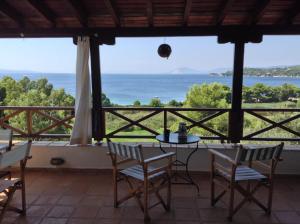 a view of the ocean from the porch of a house at Villa Bouboule in Vromolimnos