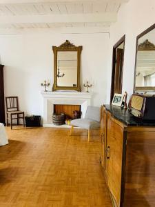 a living room with a mirror and a fireplace at Grande Maison de village ZONZA in Zonza +1 photo