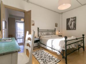 a bedroom with a bed and a desk and a table at Welcomely - Casa Margherita in Varenna
