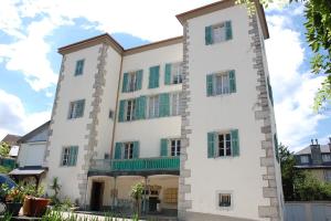 a large white building with green shutters at Romantic Suite Bellevue et Parking in Chambéry