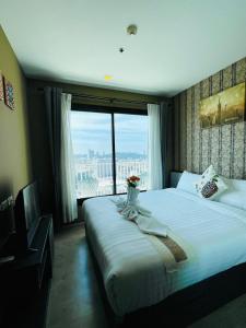 a hotel room with a bed and a large window at The base Condo luxury room by Numam in Pattaya Central