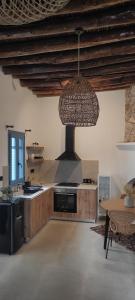 a large kitchen with a stove and a ceiling at Casa Stergia - Village Project in Psinthos
