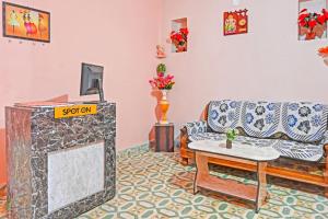 GuwārighātHotel O Maa Narmada的带沙发和桌子的客厅