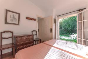 En eller flere senge i et værelse på Le Cottage l Pool & Beachside l Shellter Rentals