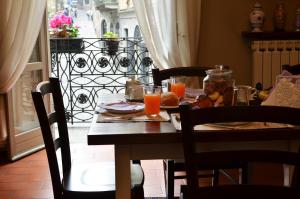 a table with food and orange juice on a balcony at La Torre Bergamo House in Bergamo
