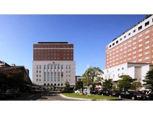 a city with two tall buildings and a street with cars at Boston Plaza Kusatsu Biwa Lake - Vacation STAY 15410v in Kusatsu