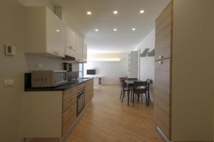 a kitchen with a counter and a dining room at La Cordata Accommodation - Martinelli 55 - Mono 7 in Rho