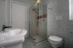 a bathroom with a shower and a toilet and a sink at La Cordata Accommodation - Martinelli 55 - Mono 7 in Rho