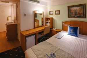 a hotel room with a bed and a desk at Boston Plaza Kusatsu Biwa Lake - Vacation STAY 15431v in Kusatsu
