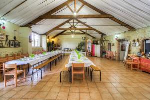 a large dining room with tables and chairs in it at Résidence L'Ogomé in Le Boupère