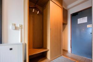 a room with a closet with a glass door at Miyazaki Mango Hotel - Vacation STAY 58252v in Miyazaki