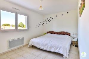 Biscarrosse bourg Duplex proche commerces 6 couchages في بيسكاروس: غرفة نوم بسرير النجوم على الحائط