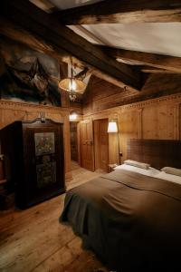 a bedroom with a large bed in a room with wooden walls at Forsthaus Wartenfels in Thalgau