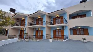 a large building with balconies and a courtyard at Tolo Blue Bay in Tolo