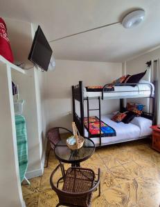 a room with two bunk beds and a table and chairs at Hotel Catalina in Orizaba