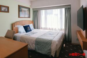 a hotel room with a bed and a window at Boston Plaza Kusatsu Biwa Lake - Vacation STAY 15460v in Kusatsu