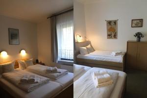 a hotel room with two beds with towels on them at Schwertlilie in Wittdün