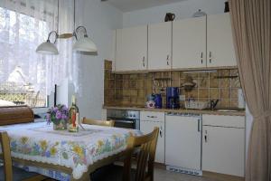 a kitchen with a table with a table cloth on it at Schwertlilie in Wittdün