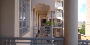 a balcony of a building with a plant on it at Kamemo la casa Homes in Nakuru
