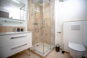 a bathroom with a glass shower and a toilet at Les Lices B l Equiped & Central l Shellter Rentals in Saint-Tropez