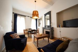 a living room with a couch and a table at Maison Gaspard - Suites et appartements de charme à Saumur in Saumur