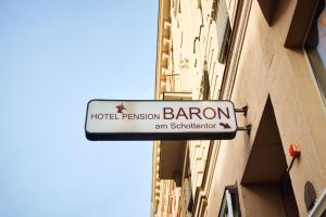 a sign for a hotel jerusalem baron on a building at Hotel Pension Baron am Schottentor in Vienna